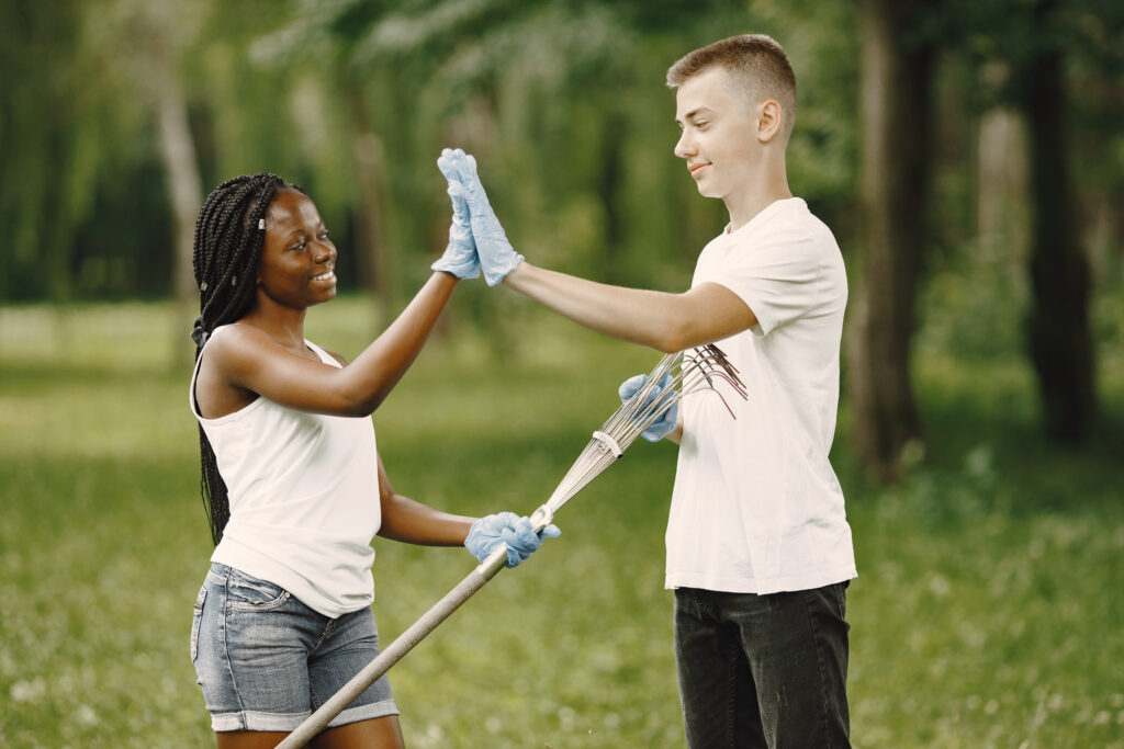 two young excited volunteers giving high five